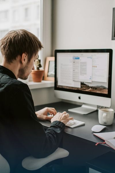 man sitting at a computer doing SEO optimization work